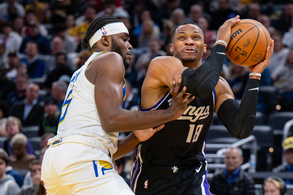 Sacramento Kings guard Russell Westbrook (18) reacts after making contact with the defense of Indiana Pacers forward Jarace Walker en route to the basket during the first half of an NBA basketball game in Indianapolis, Monday, Dec. 8, 2025. (AP Photo/Doug McSchooler)