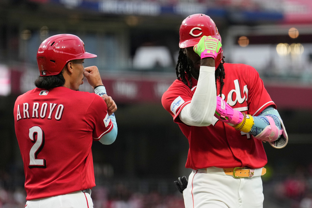 Cincinnati Reds' Elly de la Cruz, right, celebrates with Edwin Arroyo, left, after hitting a two-run homer during the fourth inning of a baseball game against the Philadelphia Phillies in Cincinnati, Wednesday, July 8, 2026. (AP Photo/Carolyn Kaster)