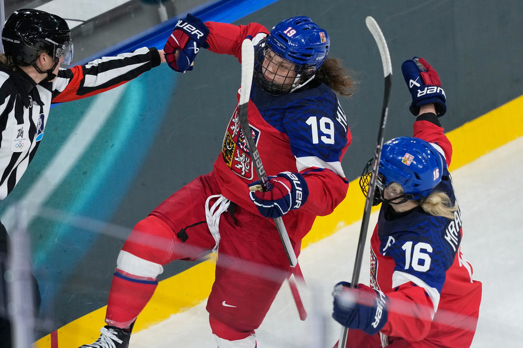 Czechia's Natalie Mlynkova, left, celebrates with Czechia's Katerina Mrazova after scoring her sides second goal during a preliminary round match of women's ice hockey between Czechia vs Finland at the 2026 Winter Olympics, in Milan, Italy, Sunday, Feb. 8, 2026. (AP Photo/Hassan Ammar)