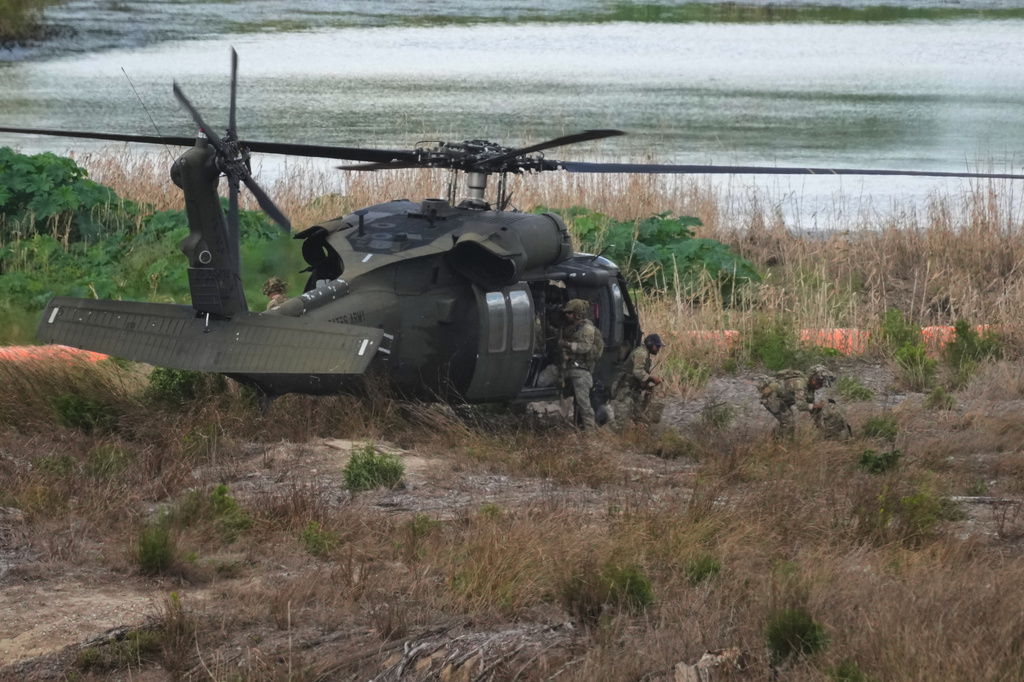 Troops disembark from a U.S. Army helicopter on an island along the Rio Grande in Roma, Texas, Thursday, Oct. 8, 2026. (AP Photo/Eric Gay)