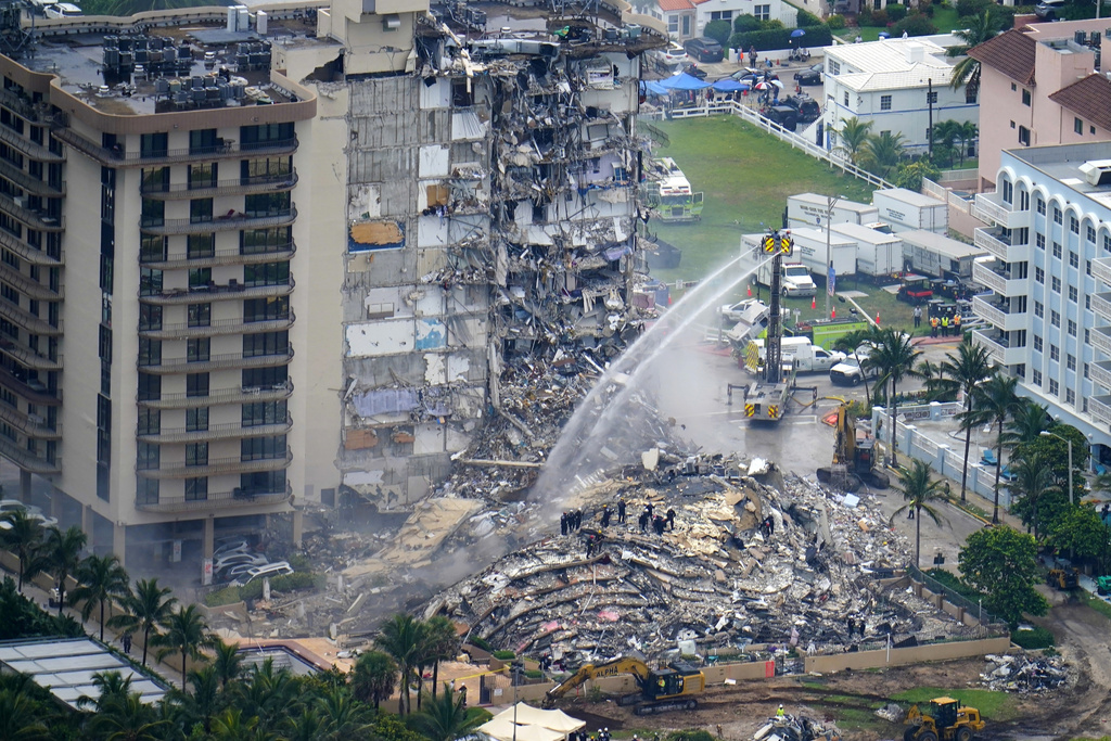 FILE - Rescue personnel work at the remains of the Champlain Towers South condo building, June 25, 2021, in Surfside, Fla. (AP Photo/Gerald Herbert, File)