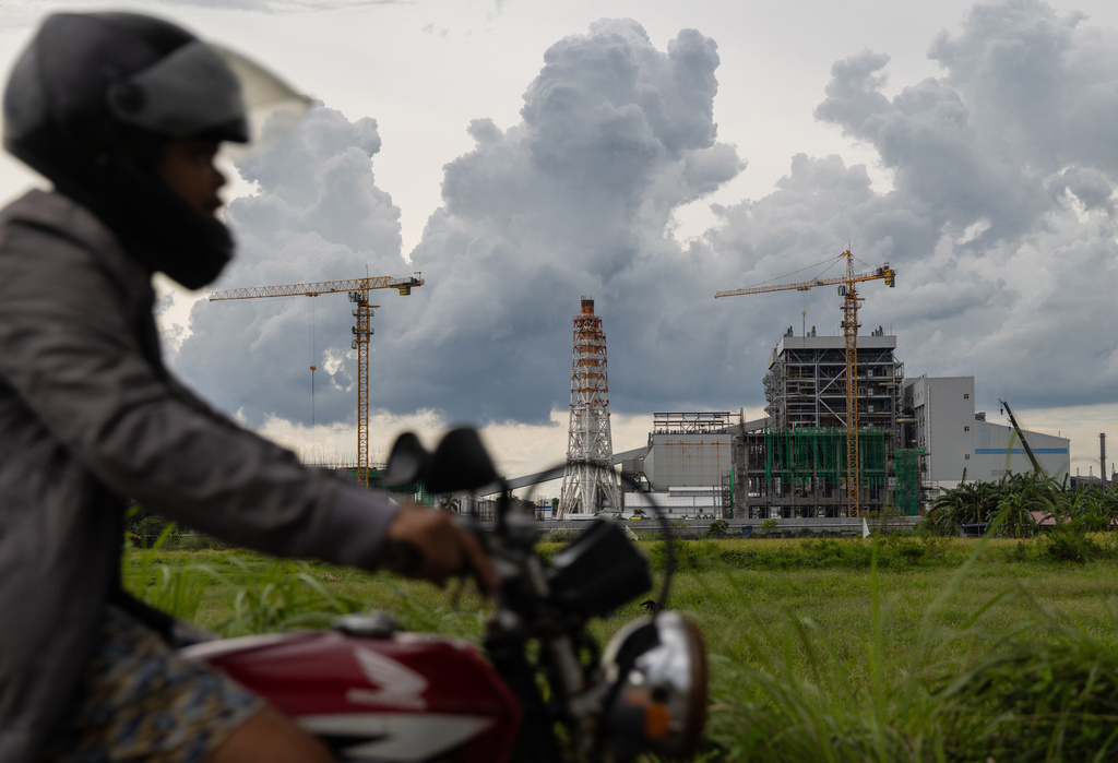 FILE - A motorcyclist drives past the South Luzon Thermal Energy Power Plant in Calaca, Batangas, in the Philippines on Oct. 4, 2025. (AP Photo/Anton L. Delgado, File)