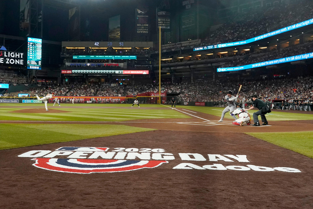 Arizona Diamondbacks pitcher Michael Soroka throws the opening-day first pitch to Detroit Tigers' Kerry Carpenter during the first inning of baseball game Monday, March 30, 2026, in Phoenix. (AP Photo/Darryl Webb)