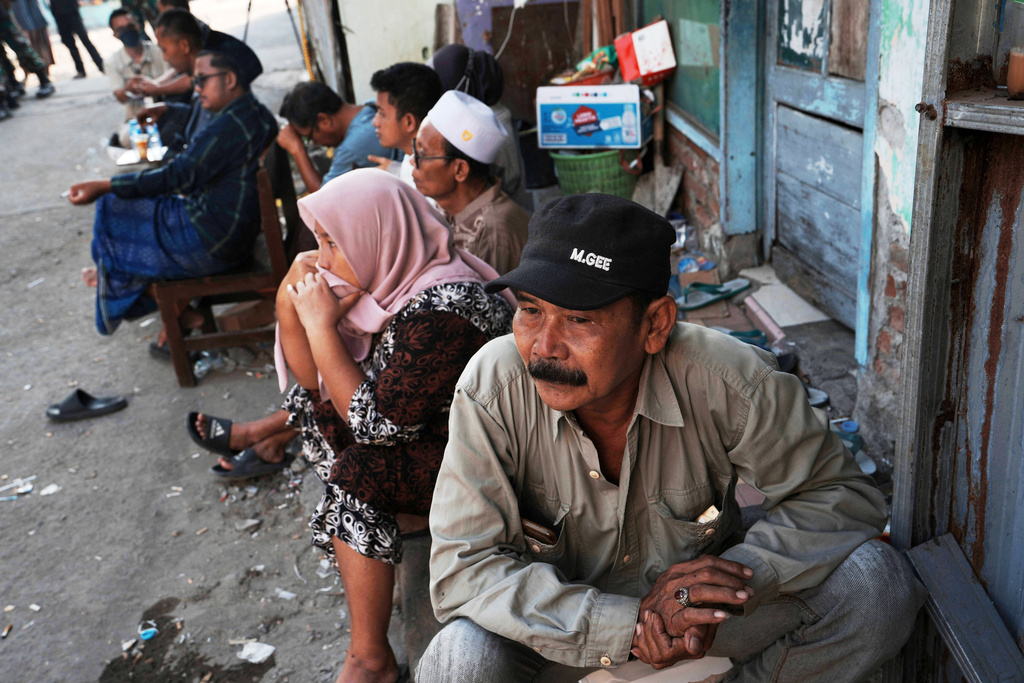 Family members of students wait as rescue efforts are underway after a building under construction collapsed at an Islamic boarding school in Sidoarjo, East Java, Indonesia, Thursday , Oct. 2, 2025. (AP Photo/Achmad Ibrahim)