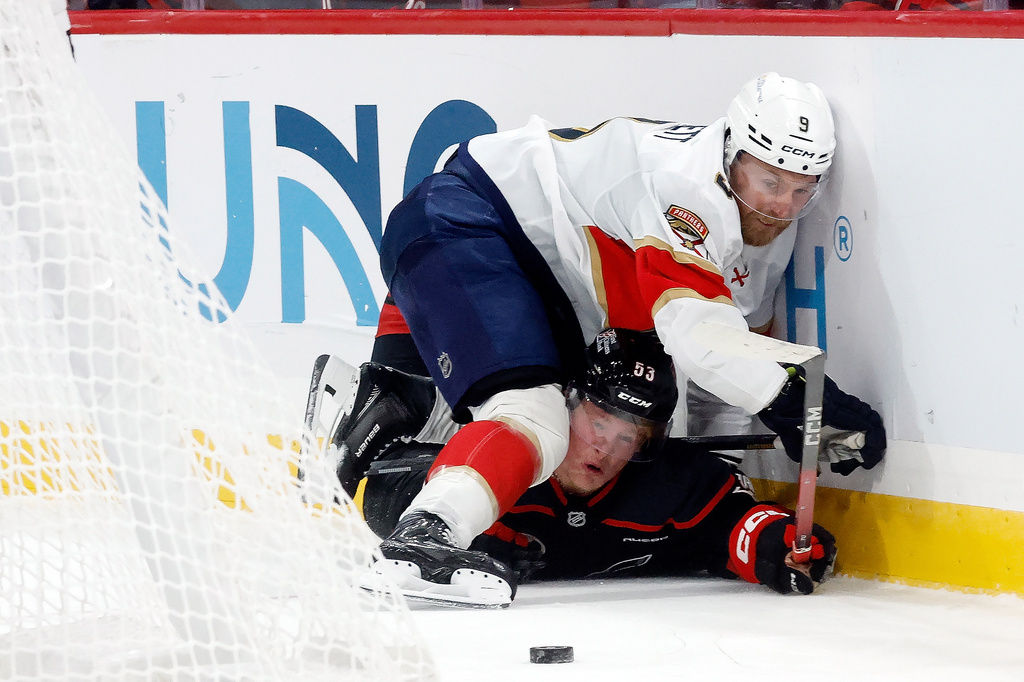 Florida Panthers' Sam Bennett (9) collides with Carolina Hurricanes' Jackson Blake (53) during the third period of an NHL hockey game in Raleigh, N.C., Tuesday, Sept. 29, 2026. (AP Photo/Karl DeBlaker)
