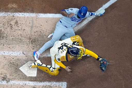 Los Angeles Dodgers' Teoscar Hernández is out at home as Milwaukee Brewers catcher William Contreras takes the throw during the fourth inning of Game 1 of baseball's National League Championship Series Monday, Oct. 13, 2025, in Milwaukee. (AP Photo/Morry Gash) Los Angeles Dodgers' Teoscar Hernández is out at home as Milwaukee Brewers catcher William Contreras takes the throw during the fourth inning of Game 1 of baseball's National League Championship Series Monday, Oct. 13, 2025, in Milwaukee. (AP Photo/Morry Gash)