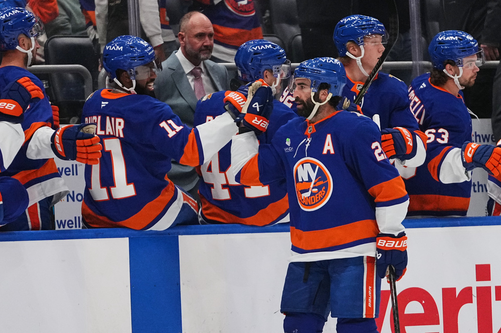 New York Islanders' Kyle Palmieri celebrates with teammates after scoring a goal during the first period of an NHL hockey game against the Vancouver Canucks Tuesday, Oct. 13, 2026, in Elmont, N.Y. (AP Photo/Frank Franklin II)