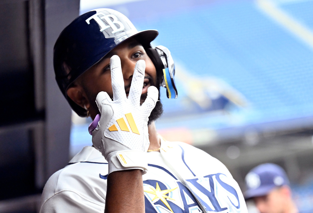 Tampa Bay Rays' Junior Caminero signals three as he celebrates his three-run home run during the eighth inning of a baseball game against the Kansas City Royals, Thursday, June 25, 2026, in St. Petersburg, Fla. Caminero had three home runs during the game. (AP Photo/Jason Behnken)