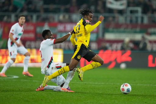 Augsburg's Chrislain Matsima, left, challenges for the ball with Dortmund's Carney Chukwuemeka during the Bundesliga soccer match between FC Augsburg and Borussia Dortmund in Augsburg, Germany, Friday, Oct. 31, 2025. (AP Photo/Matthias Schrader) Augsburg's Chrislain Matsima, left, challenges for the ball with Dortmund's Carney Chukwuemeka during the Bundesliga soccer match between FC Augsburg and Borussia Dortmund in Augsburg, Germany, Friday, Oct. 31, 2025. (AP Photo/Matthias Schrader)