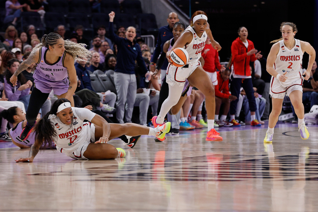 Washington Mystics forward Kiki Iriafen (44) takes the ball upcourt as players fall on the play during the second quarter of a WNBA basketball game against the Golden State Valkyries in San Francisco, Monday, July 20, 2026. (Santiago Mejia/San Francisco Chronicle via AP)