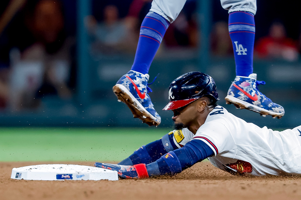 Atlanta Braves Ozzie Albies steals second base against Los Angeles Dodgers shortstop Mookie Betts during the fourth inning of a baseball game, Wednesday, Aug. 26, 2026, in Atlanta. (AP Photo/Erik S. Lesser)