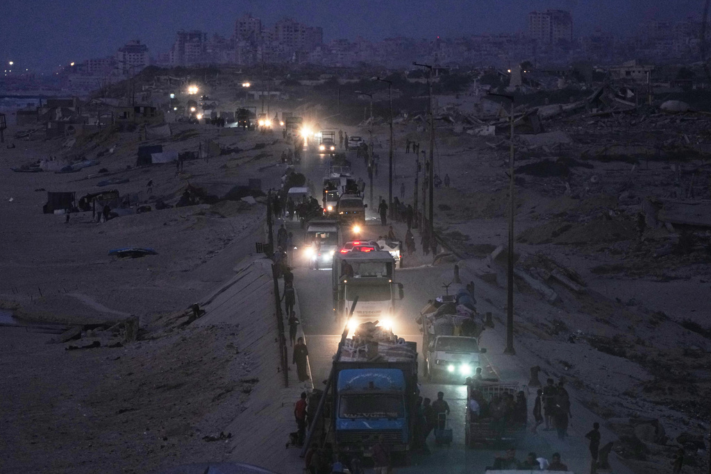 Displaced Palestinians flee northern Gaza, by vehicle and on foot, carrying their belongings along the coastal road near Wadi Gaza, Friday, Sept. 26, 2025. (AP Photo/Abdel Kareem Hana)