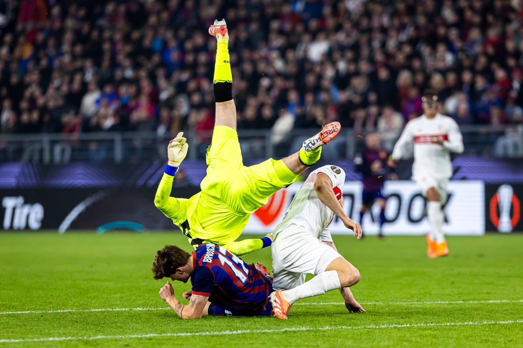 VfB Stuttgart's goalkeeper Alexander Nuebel, top, clashes with FC Basel's Moritz Broschinski, left, and Stuttgart's Ramon Hendriks during the Europa League soccer match between FC Basel and VfB Stuttgart at the St. Jakob-Park stadium in Basel, Switzerland, Thursday Oct. 2, 2025. (Michael Buholzer/Keystone via AP)