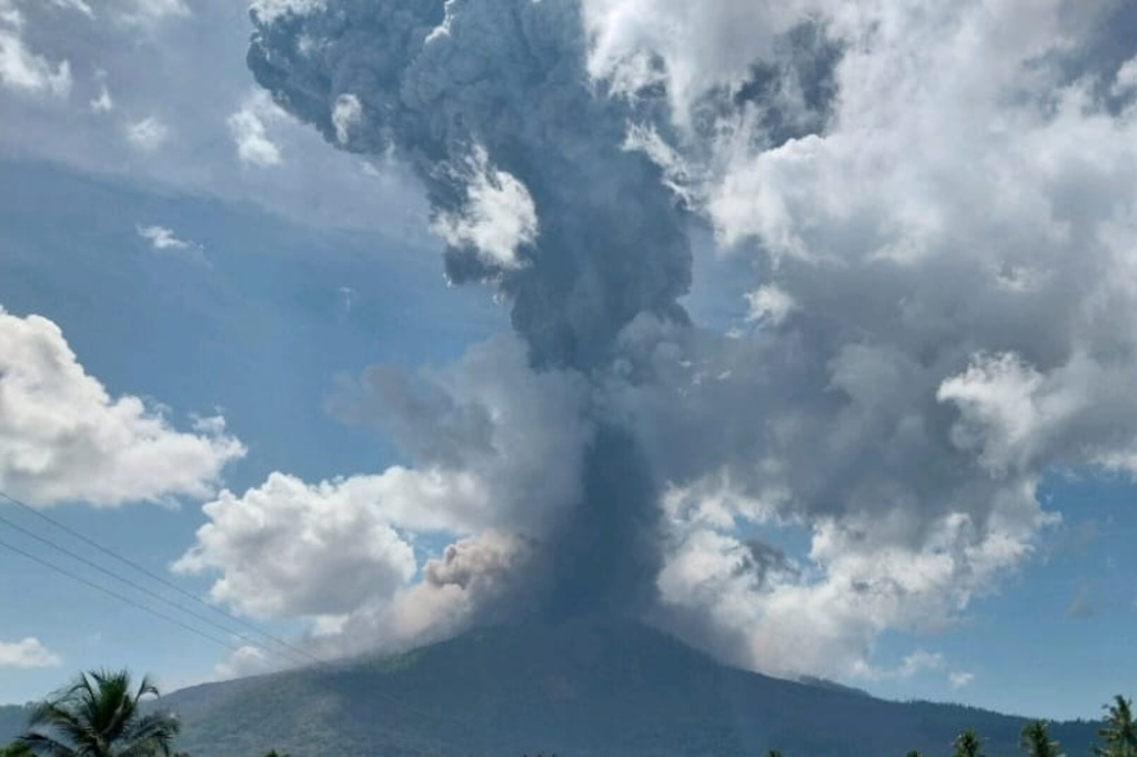 In this photo released by Geological Agency (Badan Geologi) of the Indonesia's Ministry of Energy and Mineral Resources, Mount Lewotobi Laki-Laki spews volcanic material during an eruption in East Flores, Indonesia, Wednesday, Oct. 15, 2025. (Badan Geologi via AP)