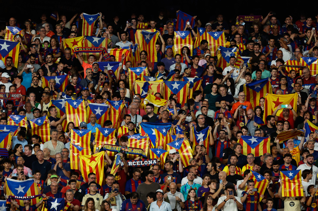 Supporters lift independence flags during a Spanish La Liga soccer match between Barcelona and Athletic in Barcelona, Spain, Thursday, Aug. 27, 2026. (AP Photo/Joan Monfort)
