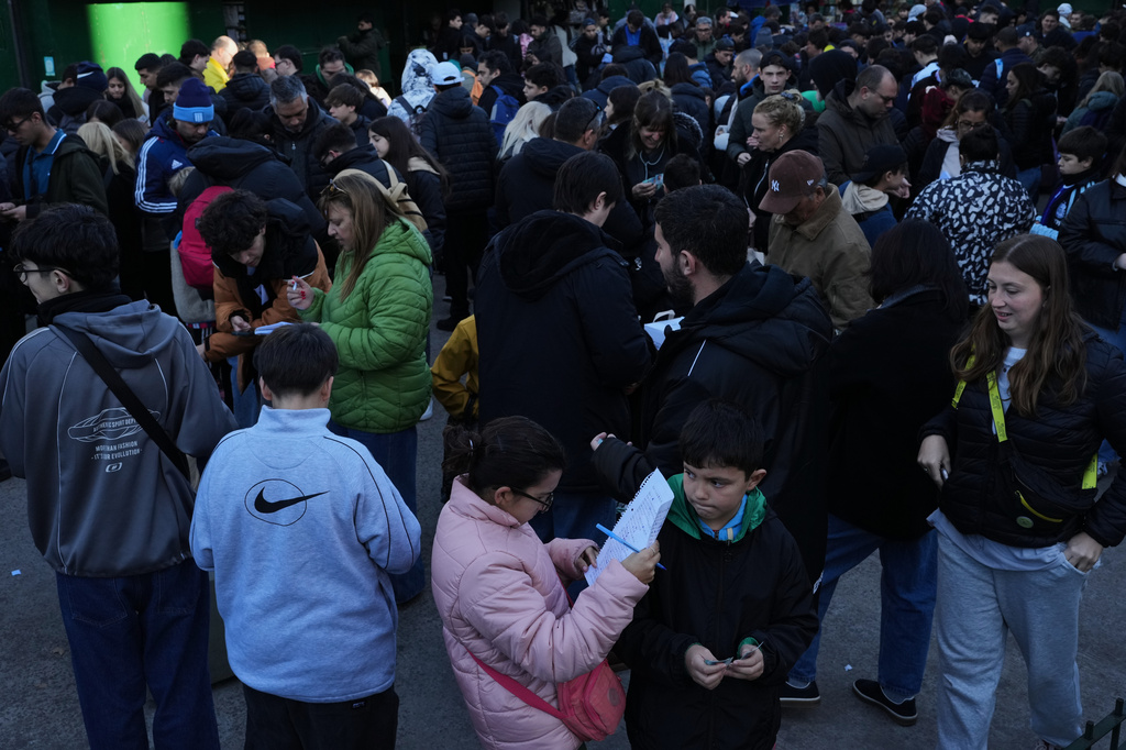 People gather at a square to exchange collectible stickers for the 2026 FIFA World Cup soccer albums in Buenos Aires, Argentina, Sunday, May 10, 2026. (AP Photo/Rodrigo Abd)