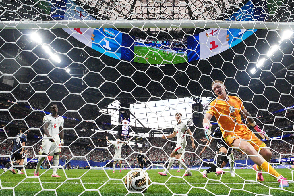 England goalkeeper Jordan Pickford (1), Marc Guehi (6), Elliot Anderson (8), and John Stones (5) react after Argentina's Lautaro Martinez scored their second goal during the World Cup semifinal soccer match between England and Argentina in Atlanta, Wednesday, July 15, 2026. (AP Photo/Jacob Kupferman)