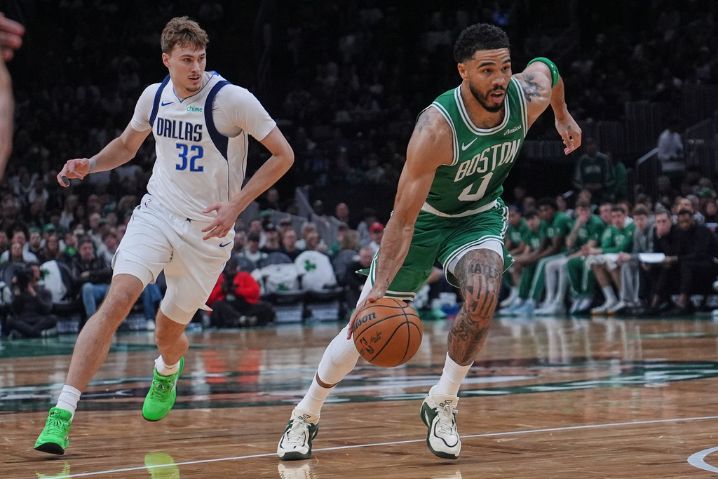 Boston Celtics forward Jayson Tatum (0) drives to the basket against Dallas Mavericks forward Cooper Flagg (32) during the second half of an NBA basketball game, Friday, March 6, 2026, in Boston. (AP Photo/Charles Krupa)
