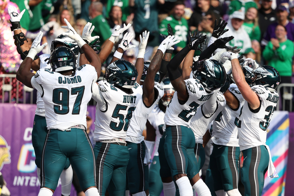 The Philadelphia Eagles celebrate after linebacker Jalyx Hunt (58) returned an interception for a touchdown during the first half of an NFL football game against the Minnesota Vikings, Sunday, Oct. 19, 2025, in Minneapolis. (AP Photo/Ellen Schmidt)