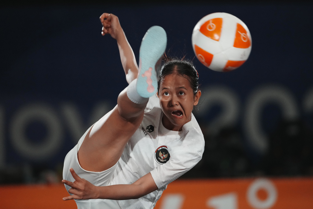 Indonesia's Sumaya plays a return against Myanmar's Khin Hnin Wai during their women's singles teqball final match at the Asian Games in Nagoya, Japan, Sunday, Sept. 20, 2026. (AP Photo/Lee Jin-man)