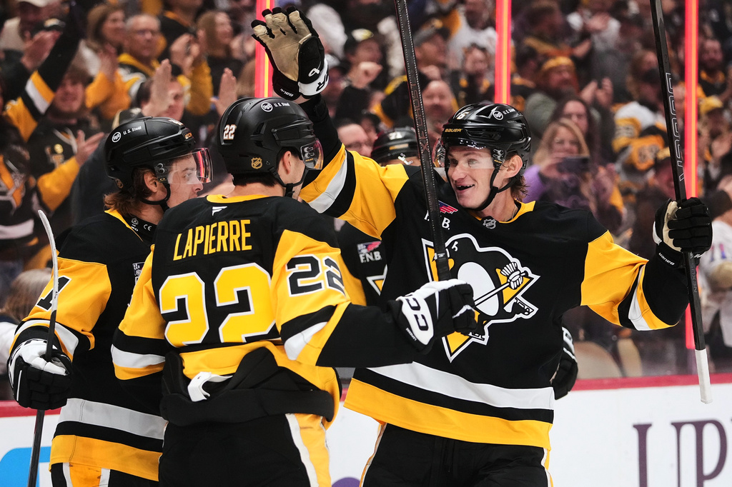 Pittsburgh Penguins' Hendrix Lapierre (22) celebrates with Kaedan Korczak (6) and Ville Koivunen, left, after scoring during the second period of an NHL hockey game against the Florida Panthers in Pittsburgh, Thursday, Oct. 22, 2026. (AP Photo/Gene J. Puskar)