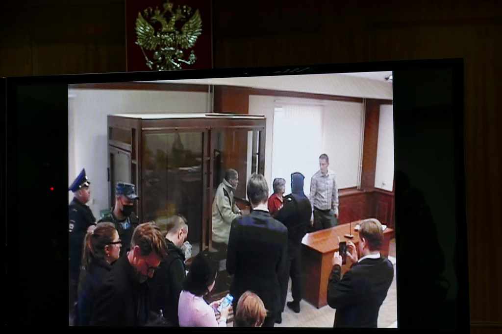 FILE - Stephen Hubbard, a U.S. citizen accused of fighting as a mercenary in Ukraine against Russia shows up in a video link as he stands in a glass cage during a court session in the Moscow City court in Moscow, Russia, Monday, Oct. 7, 2024. (AP Photo/Alexander Zemlianichenko, File)