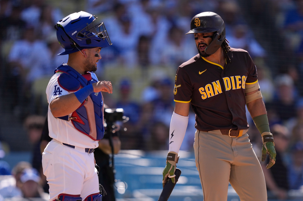 Los Angeles Dodgers catcher Eliezer Alfonzo, left, and San Diego Padres' Fernando Tatis Jr. chat as Tatis steps up to bat during the first inning of a baseball game Sunday, July 5, 2026, in Los Angeles. (AP Photo/Mark J. Terrill)
