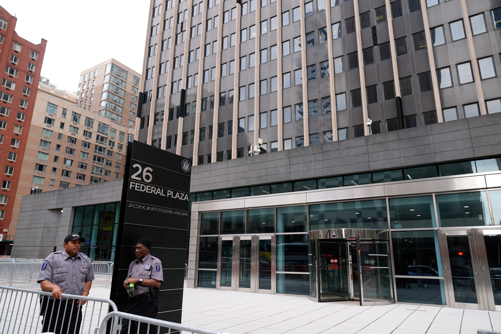 FILE - Security guards stand outside the Jacob K. Javits Federal Office Building at 26 Federal Plaza, Sept. 30, 2024, in New York. (AP Photo/Pamela Smith, file)