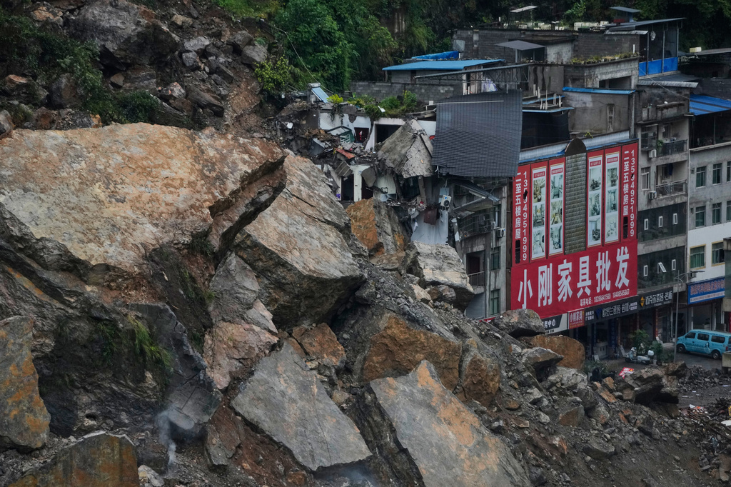 Residential and business buildings damaged by fallen rocks and mud are seen after a landslide in Pengshui County in southwestern China's Chongqing on Saturday, July 18, 2026. (AP Photo/Andy Wong)