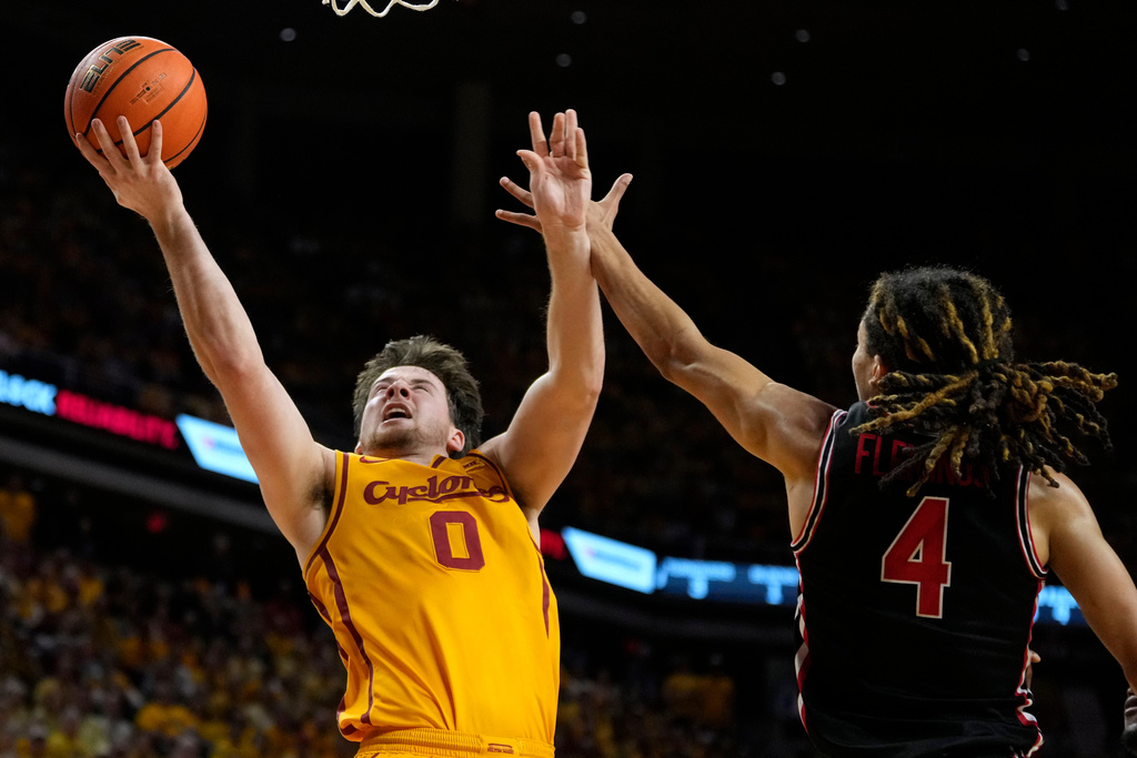 Iowa State guard Nate Heise (0) drives to the basket over Houston guard Kingston Flemings (4) during the second half of an NCAA college basketball game, Monday, Feb. 16, 2026, in Ames, Iowa. (AP Photo/Charlie Neibergall)