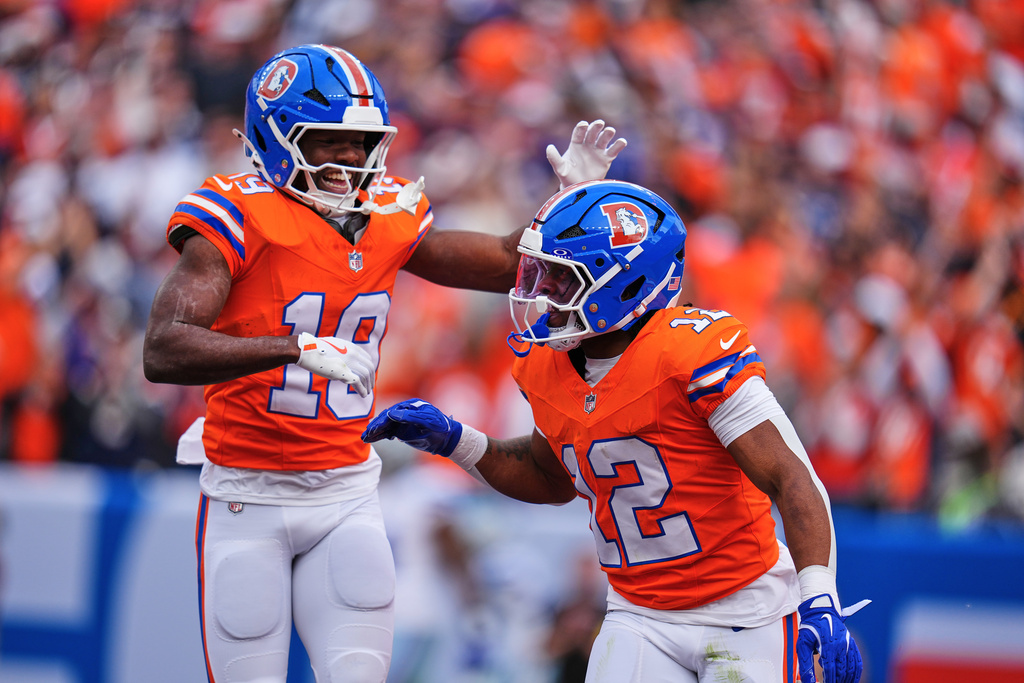 Denver Broncos' Marvin Mims Jr. (19) and RJ Harvey (12) celebrates Harvey's touchdown run in the first half of an NFL football game against the Dallas Cowboys Sunday, Oct. 26, 2025, in Denver. (AP Photo/Jack Dempsey)