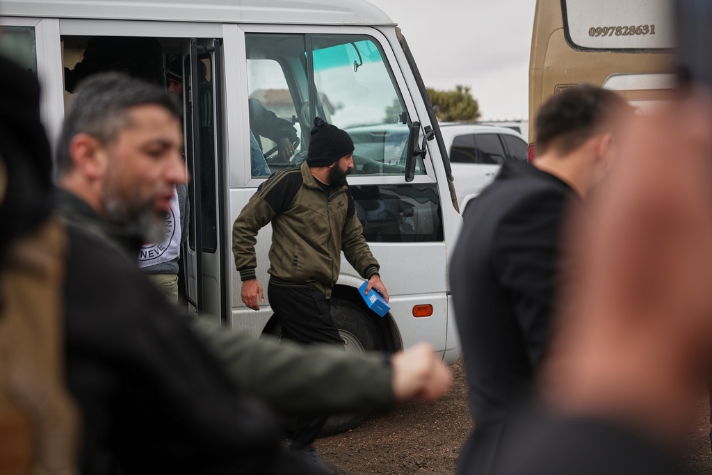 A Druze prisoner get off a minibus after his release in a prisoner exchange between Syrian government forces and Druze militiamen in Sweida province, Syria, Thursday, Feb. 26, 2026. (AP Photo/Ghaith Alsayed)