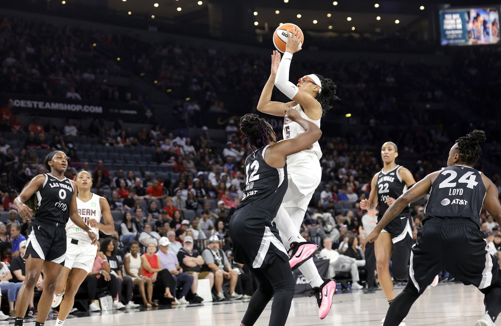Atlanta Dream guard Allisha Gray shoots over Las Vegas Aces guard Chelsea Gray (12) during the first half of a WNBA basketball game, Tuesday, Aug. 19, 2025, in Las Vegas. (Steve Marcus/Las Vegas Sun via AP)
