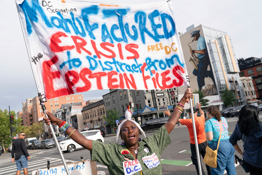 Nadine Seiler of Waldorf, Md., protests against President Donald Trump's use of federal law enforcement and National Guard troops along the U street corridor in northwest Washington Thursday, Aug. 21, 2025. (AP Photo/Jose Luis Magana)