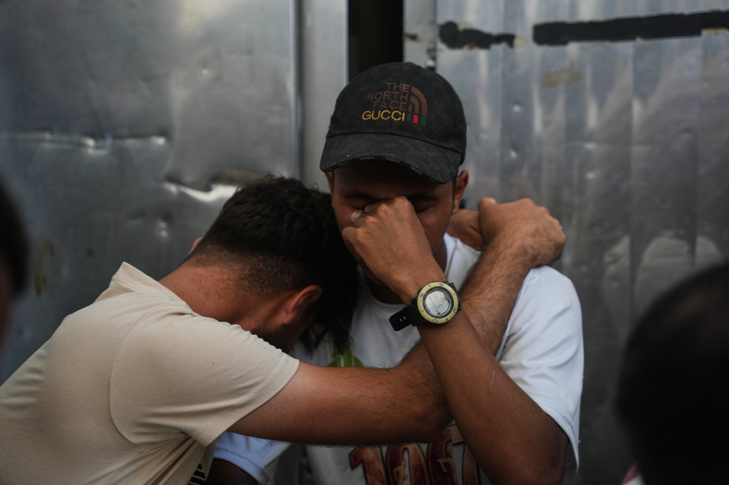 Palestinians mourn Ali Asbitan, 28, who was killed in an Israeli airstrike during his funeral at Al-Aqsa Hospital in Deir al-Balah, Gaza Strip, Monday, June 29, 2026. (AP Photo/Abdel Kareem Hana)