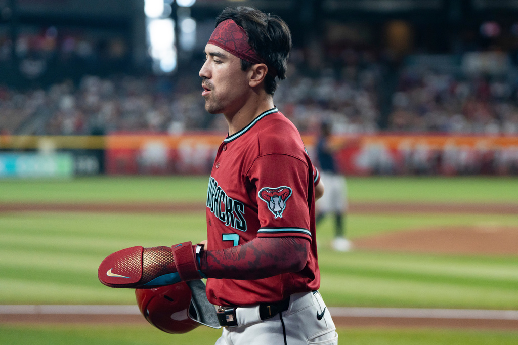 Arizona Diamondbacks' Corbin Carroll (7) jogs back to the dugout after scoring during the fourth inning of a baseball game against the Atlanta Braves, Sunday, April 5, 2026, in Phoenix. (AP Photo/Rebecca Noble)