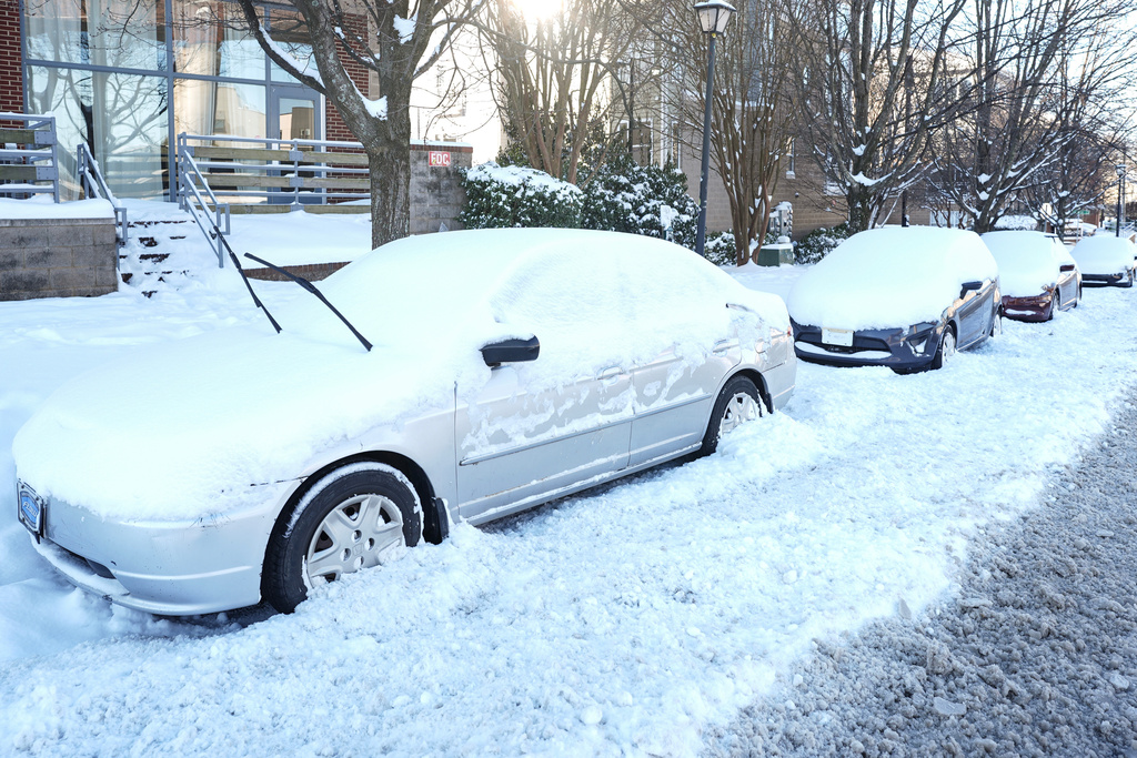 Snow covers parked cars, Sunday, Feb 1, 2026, in Charlotte, N.C. (AP Photo/Matt Kelley)