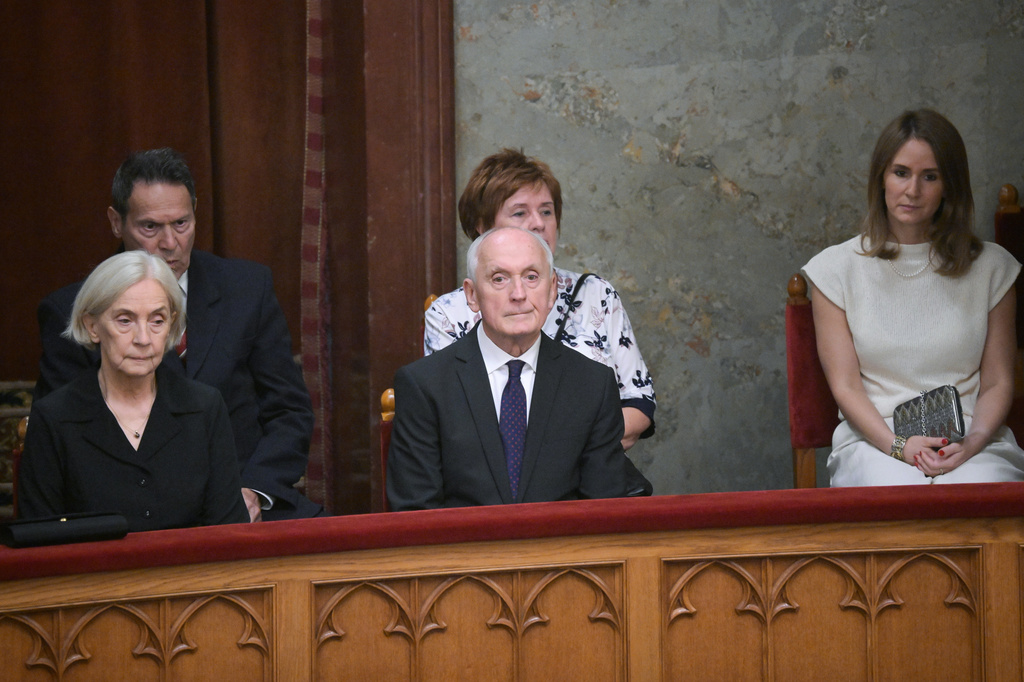 Andras Baka, sole candidate of the Tisza Party for President of the Republic of Hungary and former President of the Supreme Court, centre, attends the presidential election during the extraordinary plenary session of the Parliament in Budapest, Hungary, Tuesday, Aug.11, 2026. (Zoltan Balogh/MTI via AP)