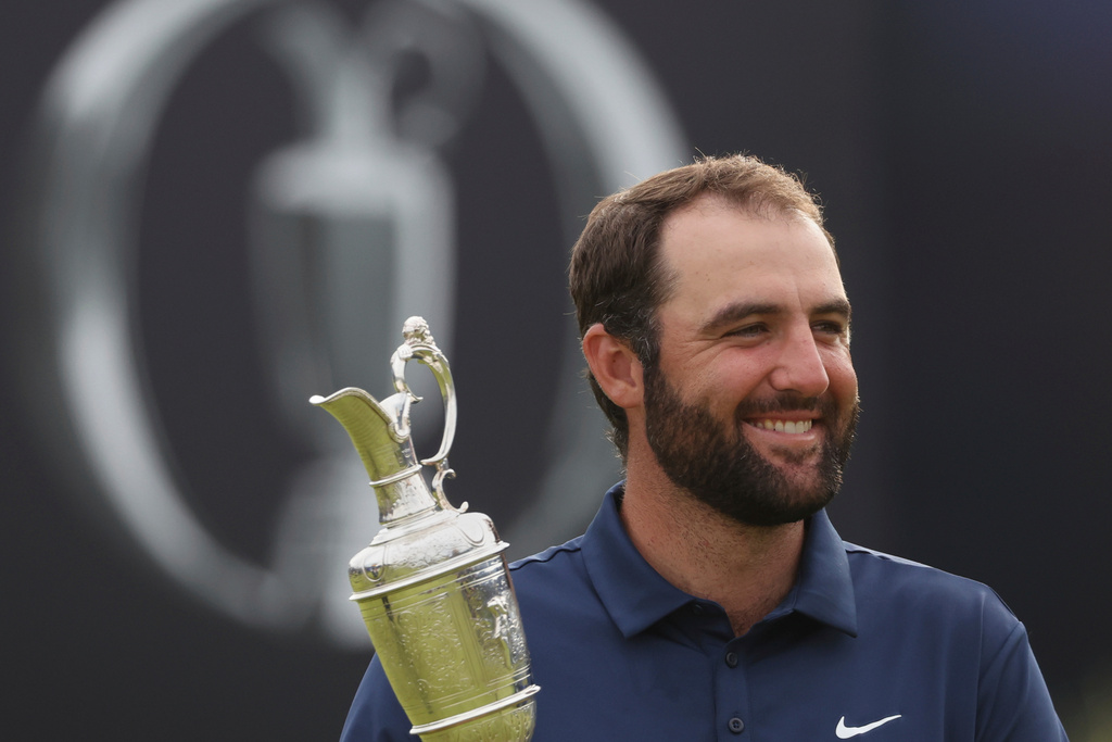 FILE - Scottie Scheffler of the United States holds the Claret Jug trophy as he poses for photographers after winning the British Open golf championship at the Royal Portrush Golf Club, Northern Ireland, July 20, 2025. (AP Photo/Peter Morrison, File)