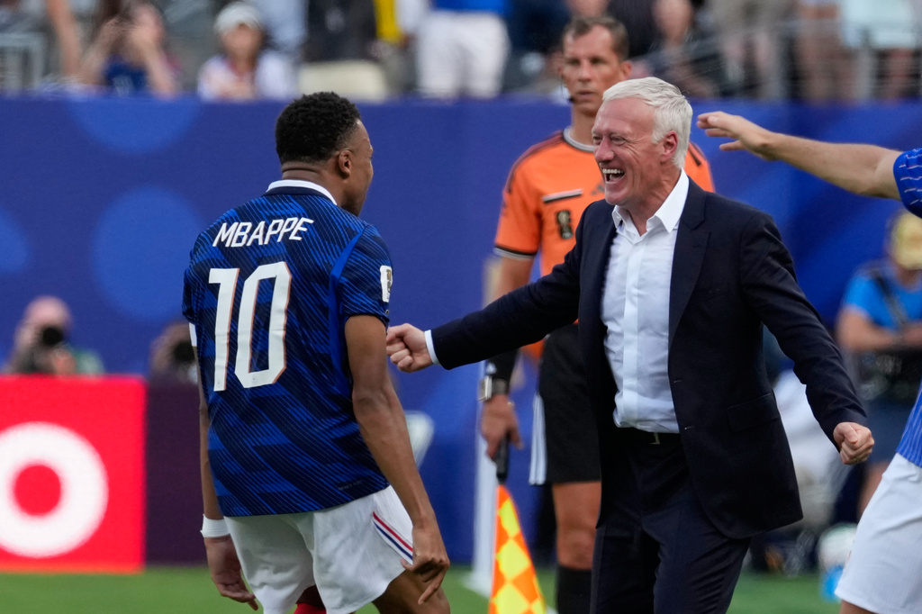 France's Kylian Mbappe, left, celebrates with his coach Didier Deschamps after scoring his side's opening goal during the World Cup round of 32 soccer match between France and Sweden in East Rutherford, N.J., near New York, Tuesday, June 30, 2026. (AP Photo/Seth Wenig)