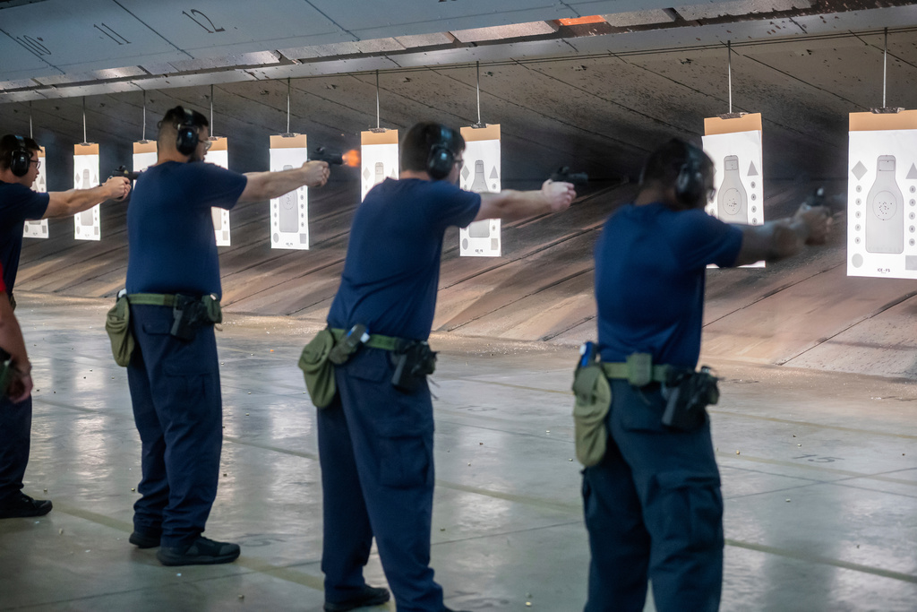 Immigration and Customs Enforcement (ICE) trainees practice shooting a handgun at the indoor firing range at the Federal Law Enforcement Training Centers (FLETC) in Brunswick, Ga. on Thursday, Aug. 21, 2025. (AP Photo/Fran Ruchalski)