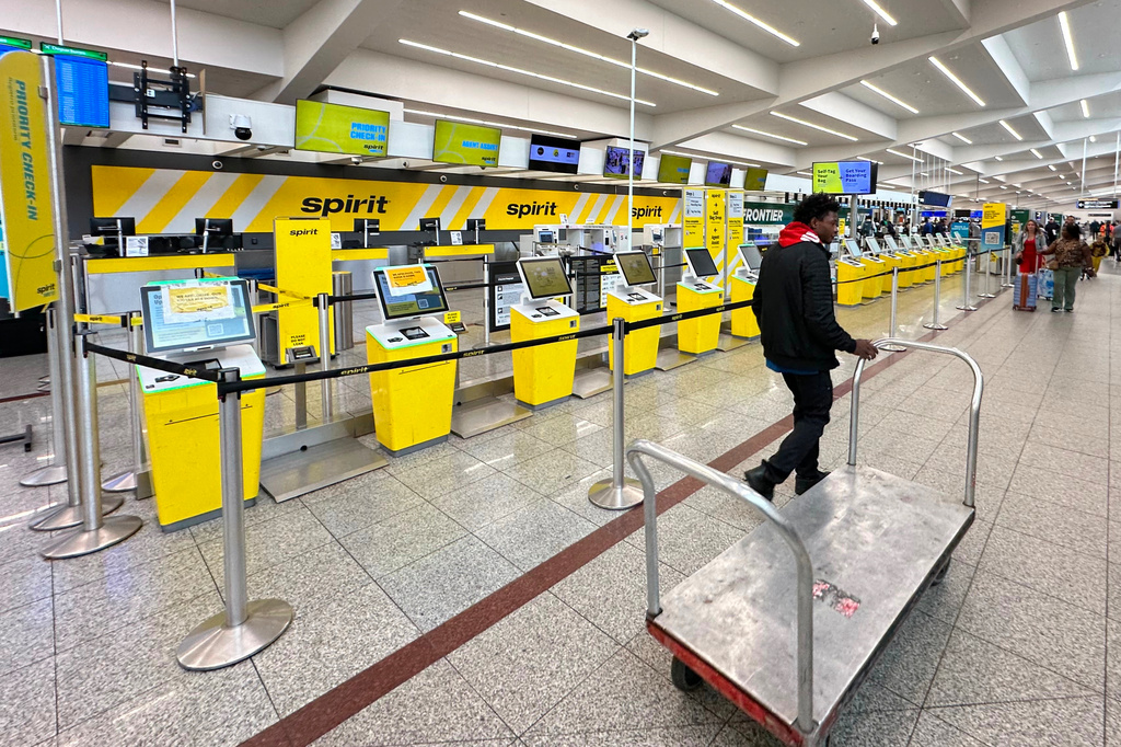 Spirit Airlines’ counter is passed by an airport employee after the airline’s shutdown on Saturday, May 2, 2026 at Hartsfield-Jackson Atlanta International Airport in Atlanta. (AP Photo/Jeff Amy)
