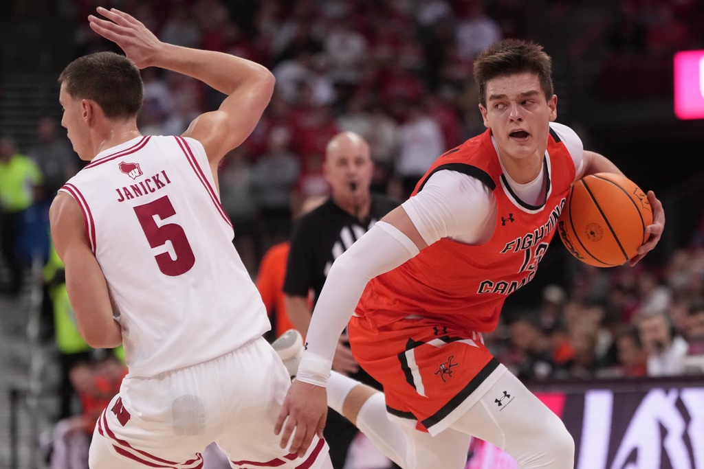Campbell's Dovydas Butka tries to get past Wisconsin's Jack Janicki during the first half of an NCAA college basketball game Monday, Nov. 3, 2025, in Madison, Wis. (AP Photo/Morry Gash)