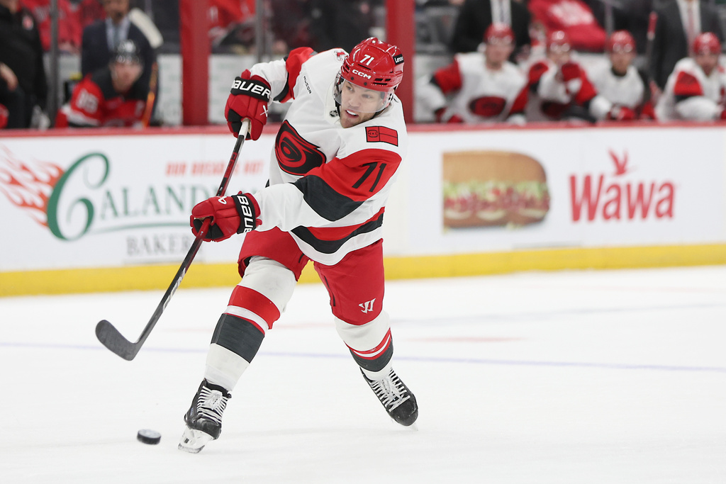 Carolina Hurricanes left wing Taylor Hall takes a shot in the first period of an NHL hockey game against the New Jersey Devils, Sunday, Jan. 4, 2026, in Newark, N.J. (AP Photo/Heather Khalifa)