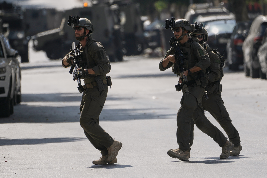 Israeli soldiers move on a street outside the Nablus Speciality Hospital in the West Bank city of Nablus, Friday, July 24, 2026, after Israeli military killed, according to health authorities, at least four Palestinians in the village of Tell in the northern West Bank. (AP Photo/Majdi Mohammed)