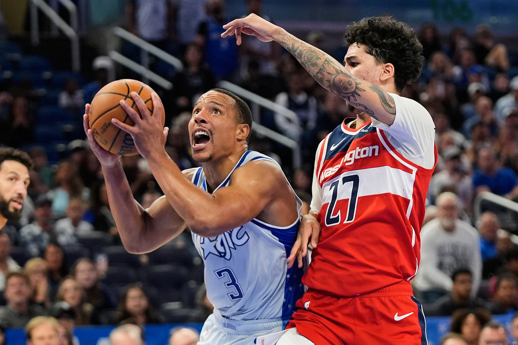 Orlando Magic guard Desmond Bane (3) goes past Washington Wizards guard Will Riley (27) for a shot during the second half of an NBA basketball game, Thursday, March 12, 2026, in Orlando, Fla. (AP Photo/John Raoux)