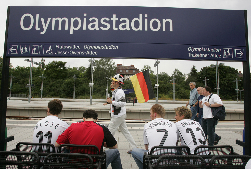 FILE - Soccer fans one carrying the German flag, arrive at the Olympiastadion station in Berlin, Friday, June 30, 2006, and head for the exit to watch the quarterfinal World Cup soccer match between Argentina and Germany being played at the nearby stadium. (AP Photo/Julie Jacobson, File)
