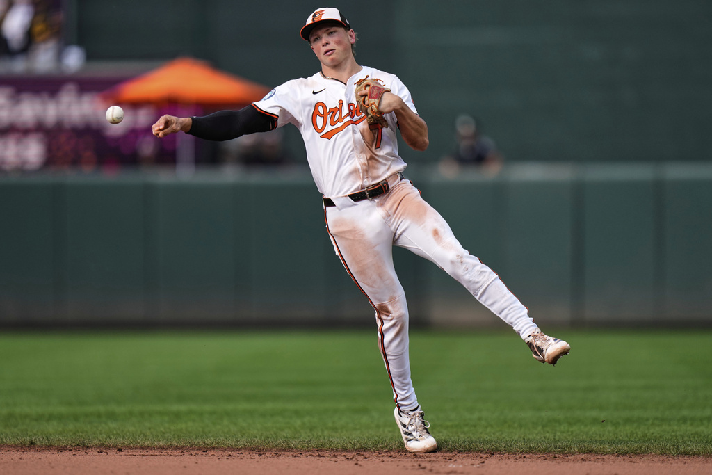 Baltimore Orioles second baseman Jackson Holliday throws to first base to make an out against Pittsburgh Pirates' Nick Yorke during the ninth inning of a baseball game, Thursday, Sept. 11, 2025, in Baltimore. (AP Photo/Stephanie Scarbrough)