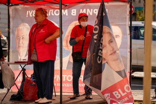 Activists wrap the posters of a campaign tent showing Irina Vlah, the leader of the Heart of Moldova party, one of four parties in the Russia-friendly Patriotic Electoral Bloc, after Moldova's electoral commission barred it from participating in this weekend's tense parliamentary elections, in Chisinau, Moldova, Friday, Sept. 26, 2025, ahead of parliamentary elections taking place on Sept. 28. (AP Photo/Vadim Ghirda) Activists wrap the posters of a campaign tent showing Irina Vlah, the leader of the Heart of Moldova party, one of four parties in the Russia-friendly Patriotic Electoral Bloc, after Moldova's electoral commission barred it from participating in this weekend's tense parliamentary elections, in Chisinau, Moldova, Friday, Sept. 26, 2025, ahead of parliamentary elections taking place on Sept. 28. (AP Photo/Vadim Ghirda)