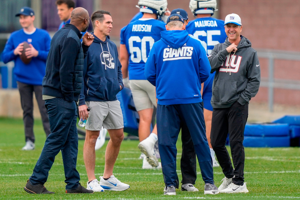 FILE - New York Giants head coach John Harbaugh, right, and New York Giants general manager Joe Schoen, second left, talk during the rookie minicamp at the NFL football team's practice facility, Saturday, May 9, 2026, in East Rutherford, N.J. (AP Photo/Yuki Iwamura, file)